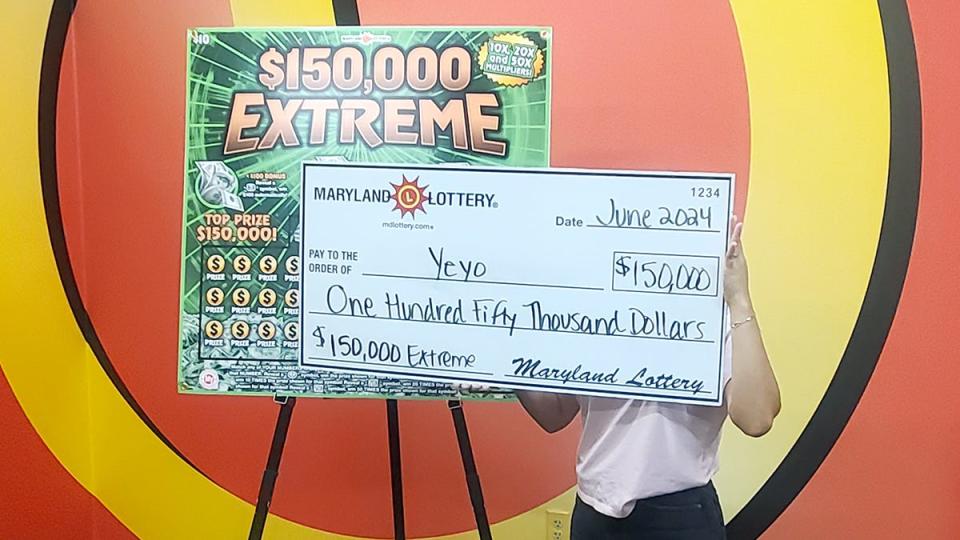 Salisbury player 'Yeyo' displays the giant check representing her big win in the Maryland Lottery's $150,000 Extreme scratch-off game.