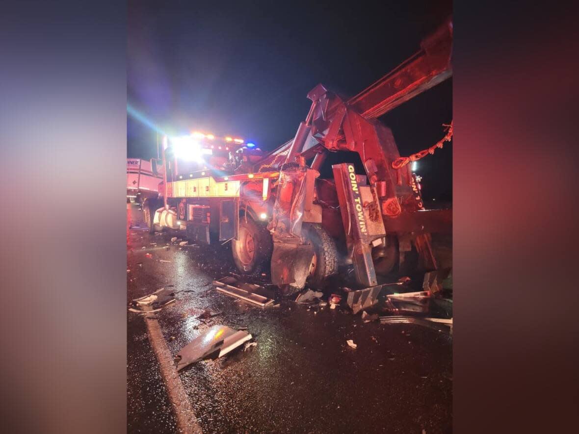 The damaged heavy wrecker tow truck after the crash on Highway 1 Tuesday evening.  (Low Cost Towing/Facebook - image credit)