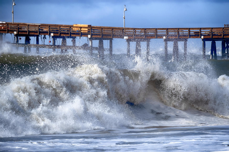 Turbulent large waves break near the Ventura Pier, Saturday, Dec. 30, 2023 in Ventura, Calif. Similar waves overran beaches elsewhere on the California coast, flooding parking lots, streets and triggering evacuation warnings for low-lying areas. (AP Photo/Richard Vogel)