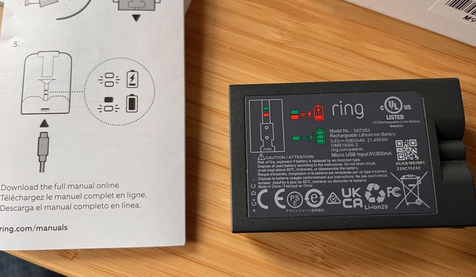 A photo of the quick-start guide's battery instructions alongside the instructions printed on the battery itself.