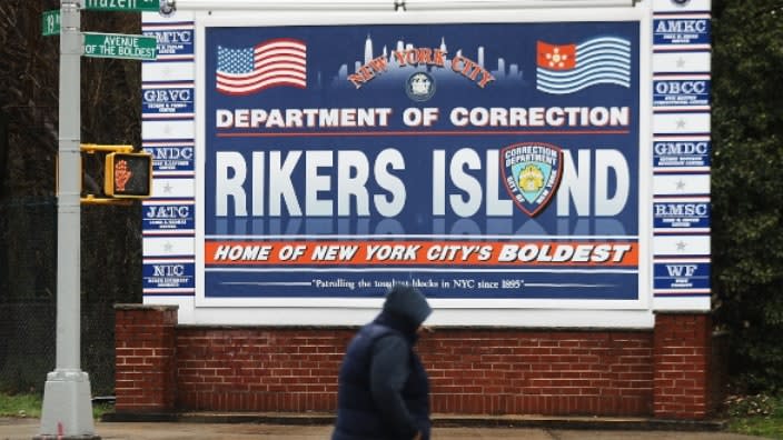 Someone walks by a sign at the entrance to Rikers Island in New York City, where an inmate died Sunday in a jail cell. His body had already begun to show signs of rigor mortis by the time it was discovered. (Photo: Spencer Platt/Getty Images)