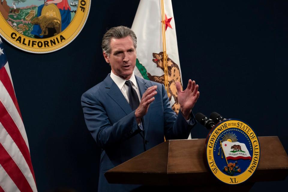 California’s governor Gavin Newsom unveils his revised 2024-25 state budget during a news conference in Sacramento on 10 May (AP)