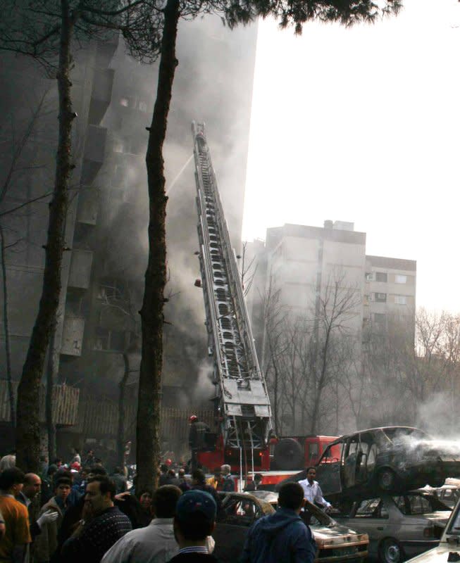 Fireman attempt to put out the fire after an army aircraft C-130 crashed into a residential building in Tehran on December 6, 2005. File Photo by Safad Farahani/UPI