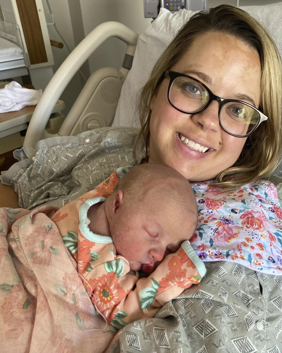 In this August 2021 photo provided the family, Sara Brown holds her newborn daughter, Suzie, at a hospital in Union City, Tenn. Early in her pregnancy, Brown decided she would wait until the baby was born to get the coronavirus vaccine. But what seemed like a sinus infection in June turned into severe COVID-19, landing her in a Nashville intensive care unit for five days, on oxygen and struggling to breathe. Suzie was born healthy, but it was a harrowing experience. (Russ Brown via AP)