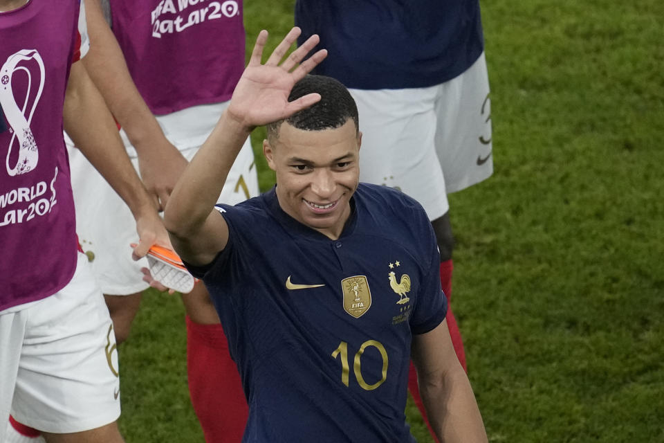 France's Kylian Mbappe waves his hand at the end of the World Cup round of 16 soccer match between France and Poland, at the Al Thumama Stadium in Doha, Qatar, Sunday, Dec. 4, 2022. (AP Photo/Christophe Ena)