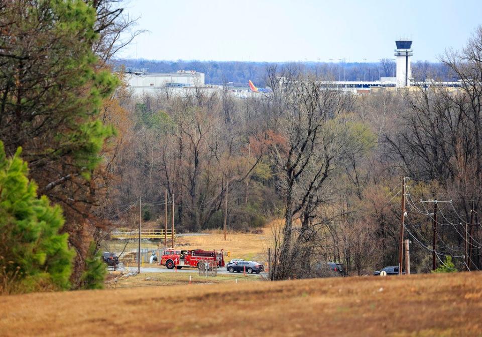 Emergency vehicles appear near the location where a small aircraft crashed while taking off from the Bill and Hillary Clinton National Airport in Little Rock, Ark., Wednesday Feb. 22, 2023. (Staton Breidenthal/Arkansas Democrat-Gazette via AP)