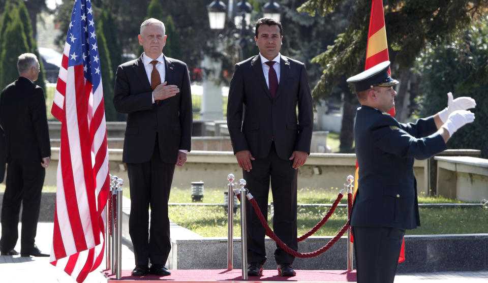 U.S. Defense Secretary James Mattis, center left, and Macedonian Prime Minister Zoran Zaev, center right, observe the national anthems during a welcome ceremony at the government building in Skopje, Macedonia, Monday, Sept. 17, 2018. Mattis arrived in Macedonia Monday, condemning Russian efforts to use its money and influence to build opposition to an upcoming vote that could pave the way for the country to join NATO, a move Moscow opposes. (AP Photo/Boris Grdanoski)