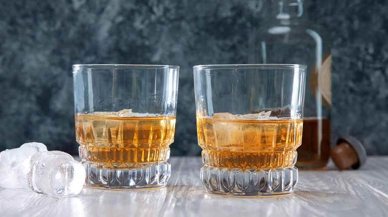 Two glasses of whiskey with ice