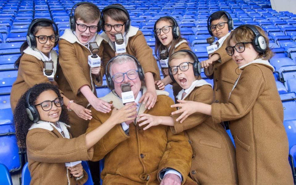 John Motson with a group of young lookalikes - John Motson, the voice of BBC football commentary, dies aged 77 - PA/Anthony Upton