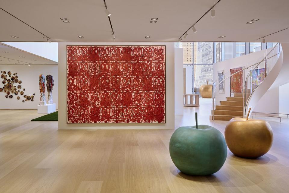 a room with a large red wall and a large round green ball