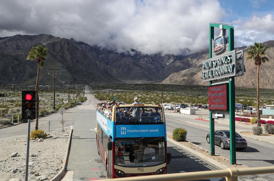 A double decker bus gives people a tour of Modernism architecture during Modernism Week in Palm Springs, Calif., Feb. 21, 2024.