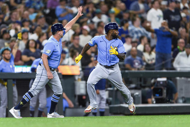 Tampa Bay Rays' Josh Lowe, left, tugs on the jersey of his brother