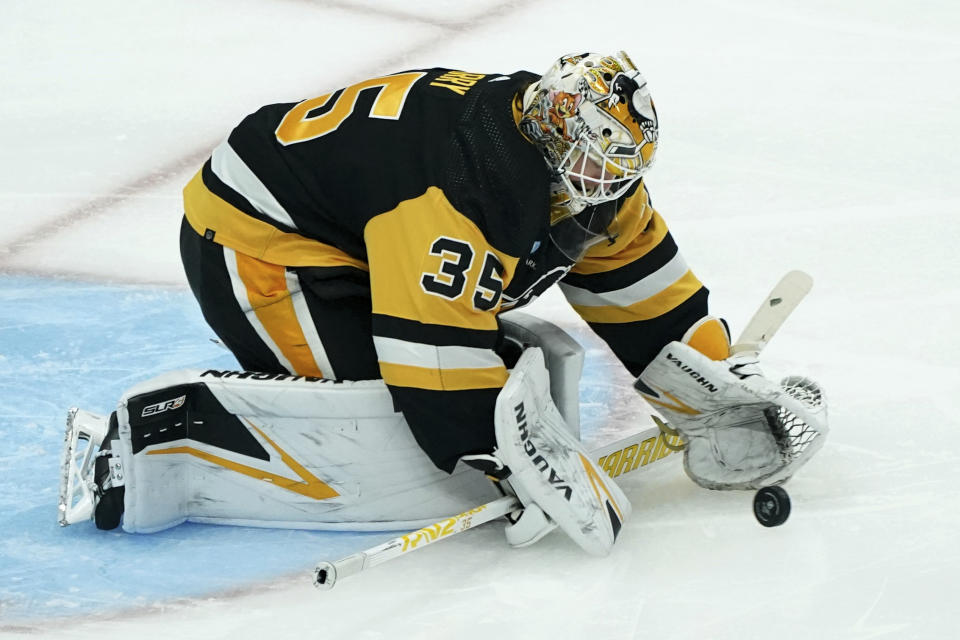 Pittsburgh Penguins goaltender Tristan Jarry reaches to stop a shot during the first period of an NHL hockey game against the St. Louis Blues, Saturday, Dec. 30, 2023, in Pittsburgh. (AP Photo/Matt Freed)