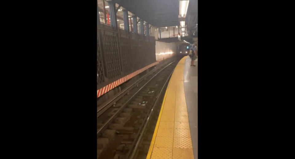 A screenshot of a video showing a train pulling into the station just seconds after the man was pulled to safety, and his rescuer also jumped back onto the platform. Source: Twitter/SubwayCreatures