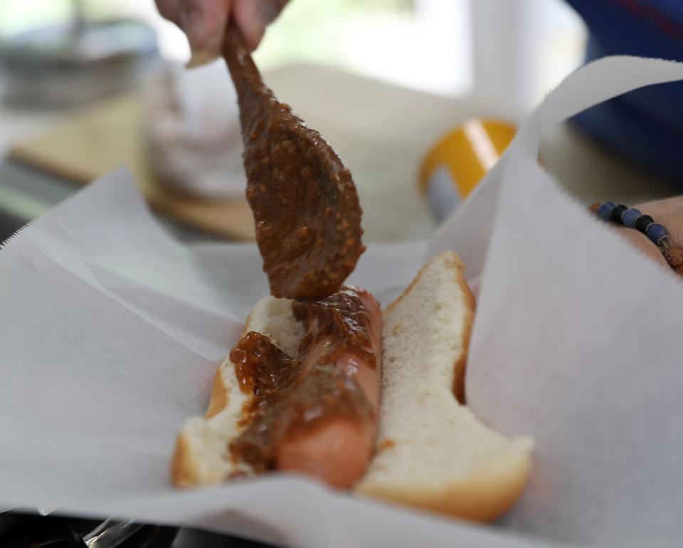 Pam Moustakas prepares a hot dog with her home made chili at Pam's Bun 'N' Run in Pleasant Valley on June 30, 2021.  