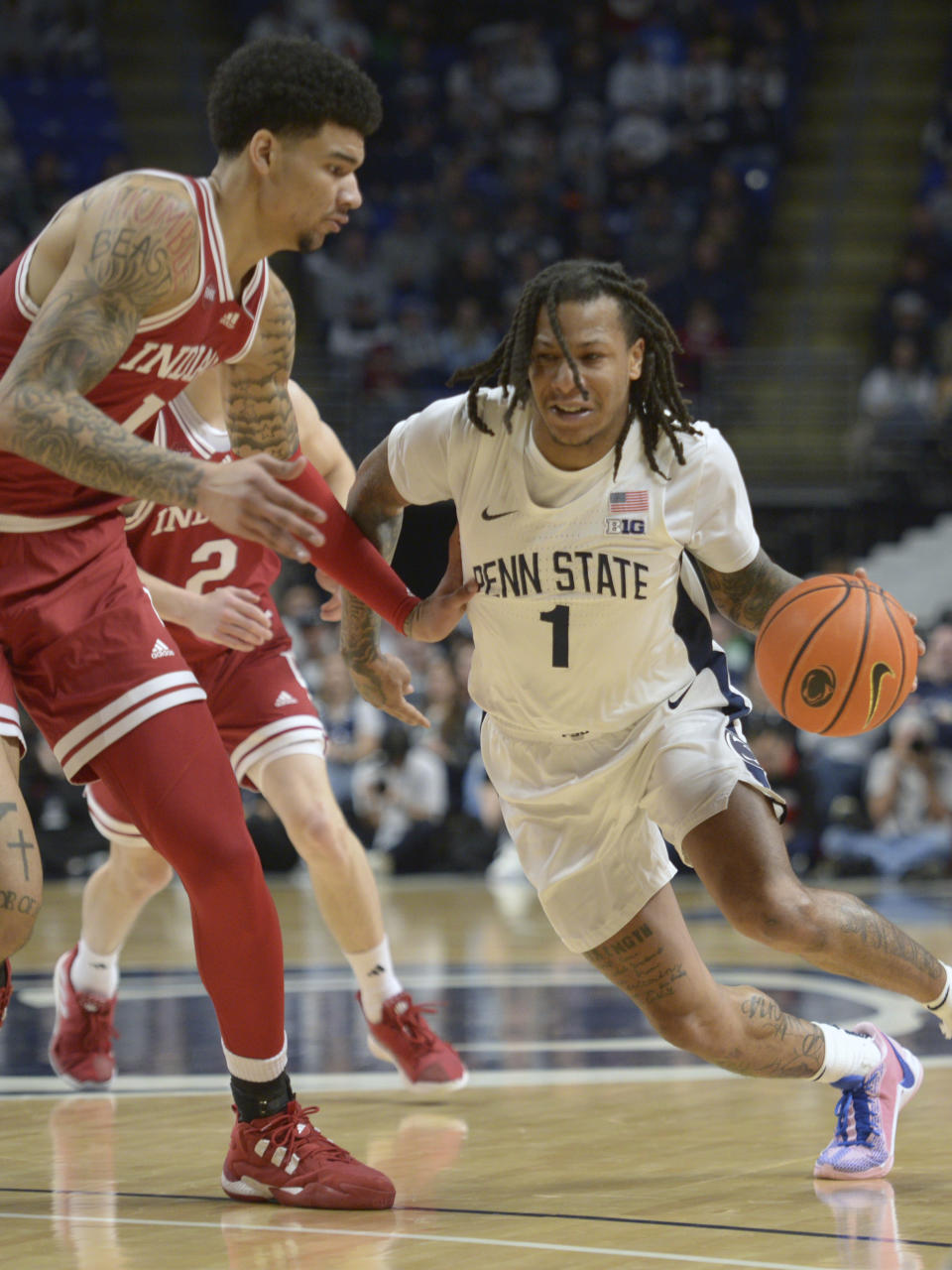 Penn State's Ace Baldwin Jr. (1) drives to the basket on Indiana's Kel'el Ware (1) during the first half of an NCAA college basketball game Saturday Feb. 24, 2024, in State College, Pa. (AP Photo/Gary M. Baranec)