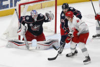 Columbus Blue Jackets' Joonas Korpisalo, left, makes a save as teammate David Savard, center, and Detroit Red Wings' Luke Glendening fight for position during the second period of an NHL hockey game Tuesday, March 2, 2021, in Columbus, Ohio. (AP Photo/Jay LaPrete)