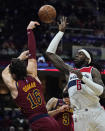 Washington Wizards' Montrezl Harrell (6) and Cleveland Cavaliers' Cedi Osman (16) battle for a rebound in the second half of an NBA basketball game, Wednesday, Nov. 10, 2021, in Cleveland. Washington won 97-94. (AP Photo/Tony Dejak)