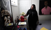 In this July 8, 2021, photo Latrice Felix whose son Alan Womack Jr. was was killed in 2020 during a fight, places her hand on a box she leaves notes to him in, during an interview with The Associated Press in King of Prussia, Pa. (AP Photo/Matt Rourke)