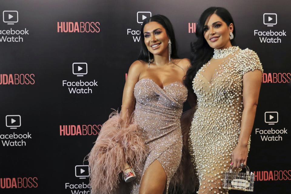 Huda Kattan, left, and Mona Kattan, pose at the Huda Boss on Facebook Watch screening celebration in Dubai, United Arab Emirates, Wednesday, Oct. 9, 2019. (AP Photo/Kamran Jebreili)