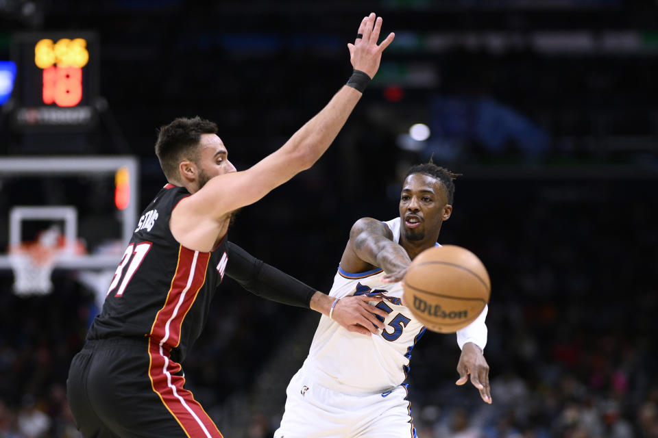 Washington Wizards guard Delon Wright, right, passes the ball past Miami Heat guard Max Strus during the first half of an NBA basketball game Friday, April 7, 2023, in Washington. (AP Photo/Nick Wass)