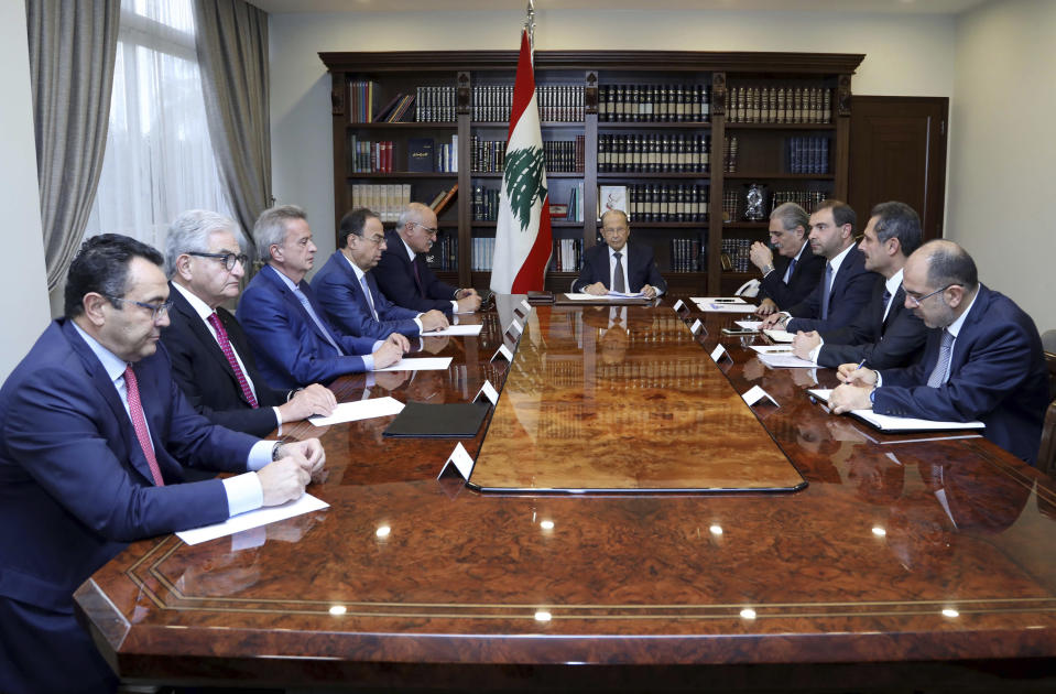 In this photo released by the Lebanese Government, Lebanese President Michel Aoun, center, meets with the country's top economic officials, at the Presidential Palace in Baabda, east of Beirut, Lebanon, Friday, Nov. 29, 2019. Friday's meeting is being attended by the ministers of economy and finance as well as Central Bank administrators and the head of the banking association. (Dalati Nohra/Lebanese Government via AP)