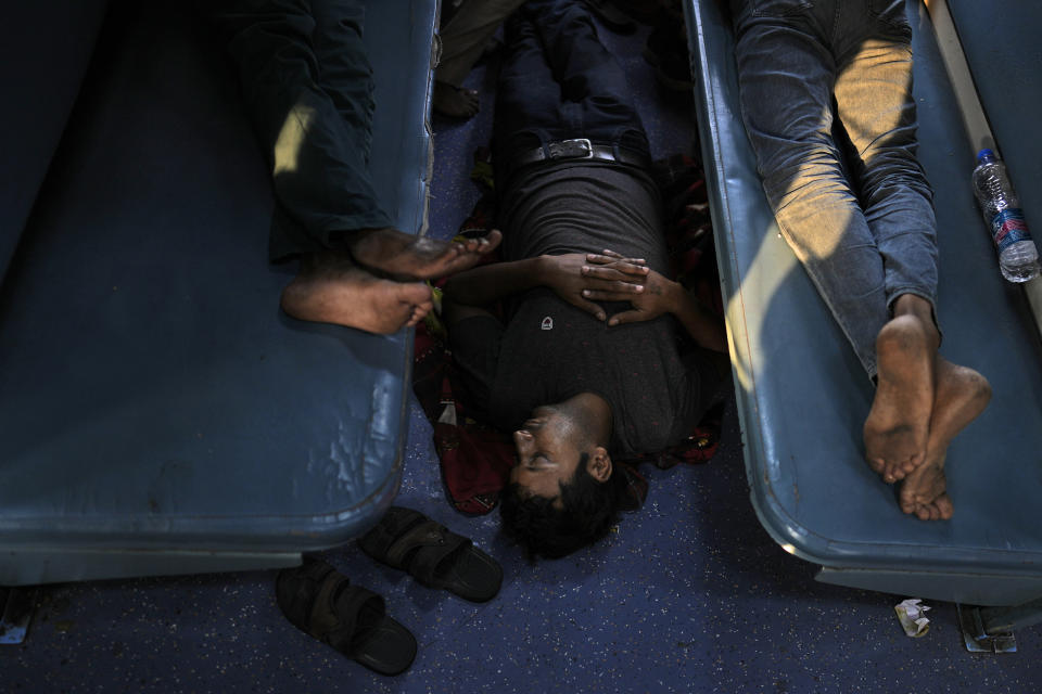 Passengers rest in a general class of the Thirukkural Express, India, Sunday, April 21, 2024. (AP Photo/Manish Swarup)