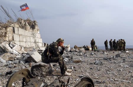 A Pro-Russian separatist sits at his position at Savur-Mohyla, a hill east of the city of Donetsk, August 28, 2014. REUTERS/Maxim Shemetov