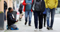 A beggar is pictured on a street in Quedlinburg, Germany, May 4, 2019. Picture taken May 4, 2019. REUTERS/Fabrizio Bensch