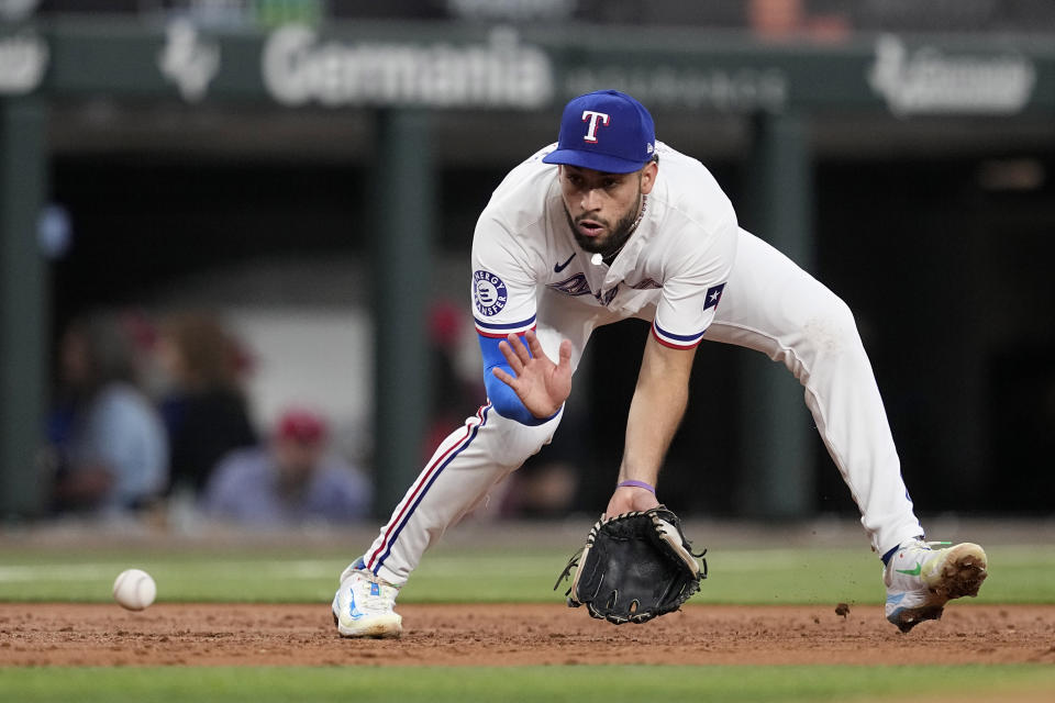 Texas Rangers third baseman Jonathan Ornelas reaches out to field a ground ball hit by Tampa Bay Rays' Jonny DeLuca in the second inning of a baseball game in Arlington, Texas, Saturday, July 6, 2024. DeLuca was out at first on the play. (AP Photo/Tony Gutierrez)