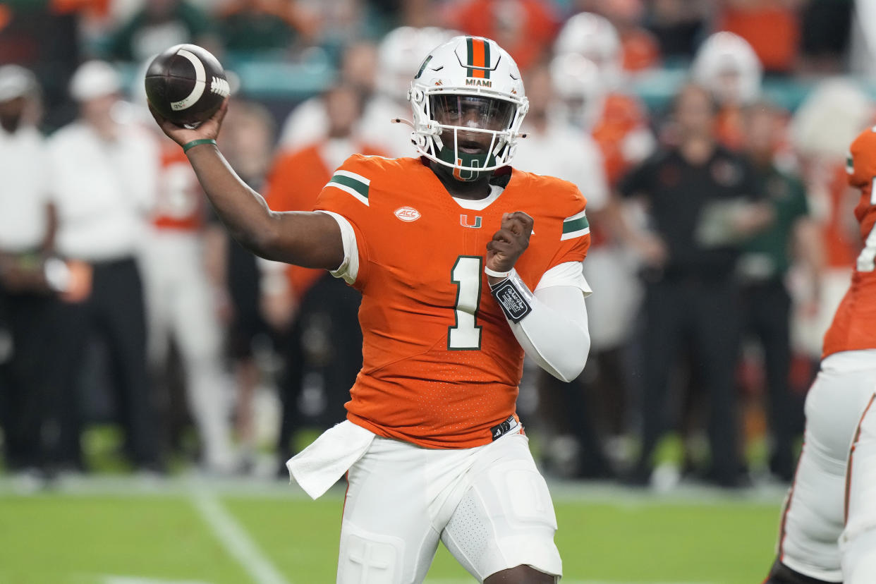 Miami quarterback Cam Ward (1) aims a pass during the first half of an NCAA college football game against Virginia Tech, Friday, Sept. 27, 2024, in Miami Gardens, Fla. (AP Photo/Marta Lavandier)