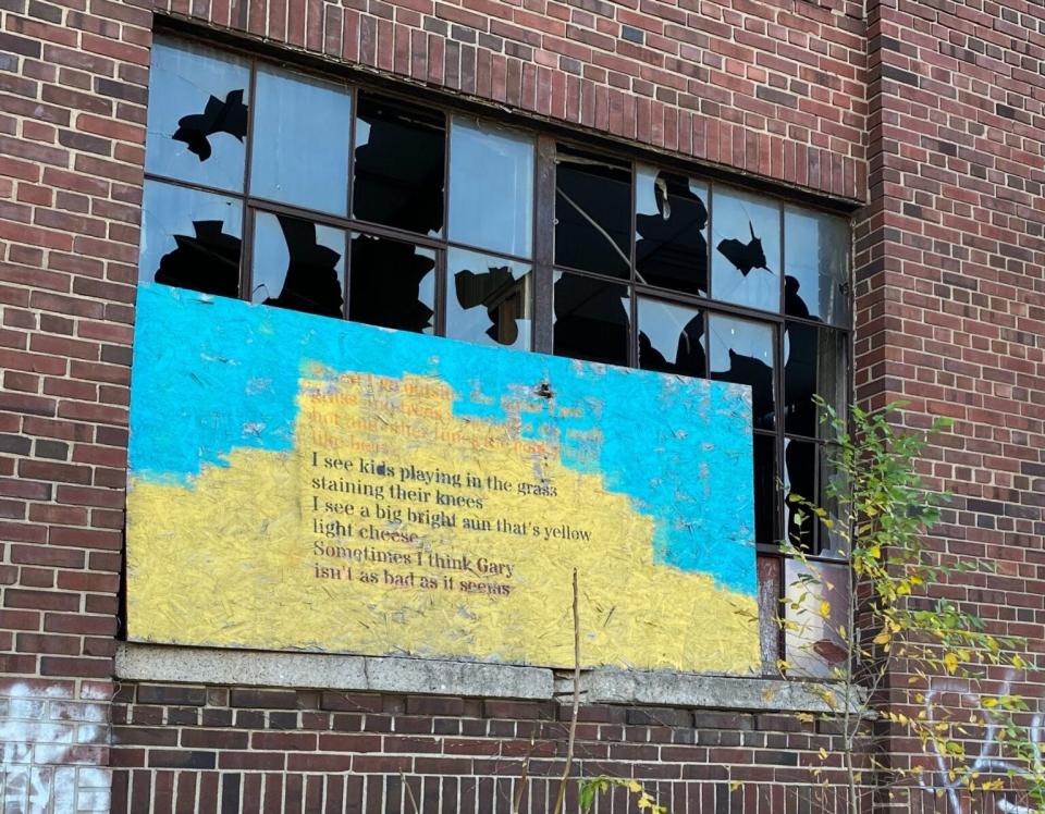 Poetry stenciled on boards adorns one of Gary, Indiana’s thousands of abandoned buildings.