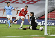 Arsenal's Pierre-Emerick Aubameyang, centre, scores his team's second goal during the FA Cup semifinal soccer match between Arsenal and Manchester City at Wembley in London, England, Saturday, July 18, 2020. (AP Photo/Justin Tallis,Pool)