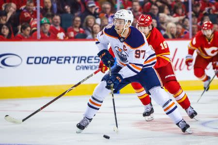 Apr 6, 2019; Calgary, Alberta, CAN; Edmonton Oilers center Connor McDavid (97) controls the puck against the Calgary Flames during the first period at Scotiabank Saddledome. Mandatory Credit: Sergei Belski-USA TODAY Sports