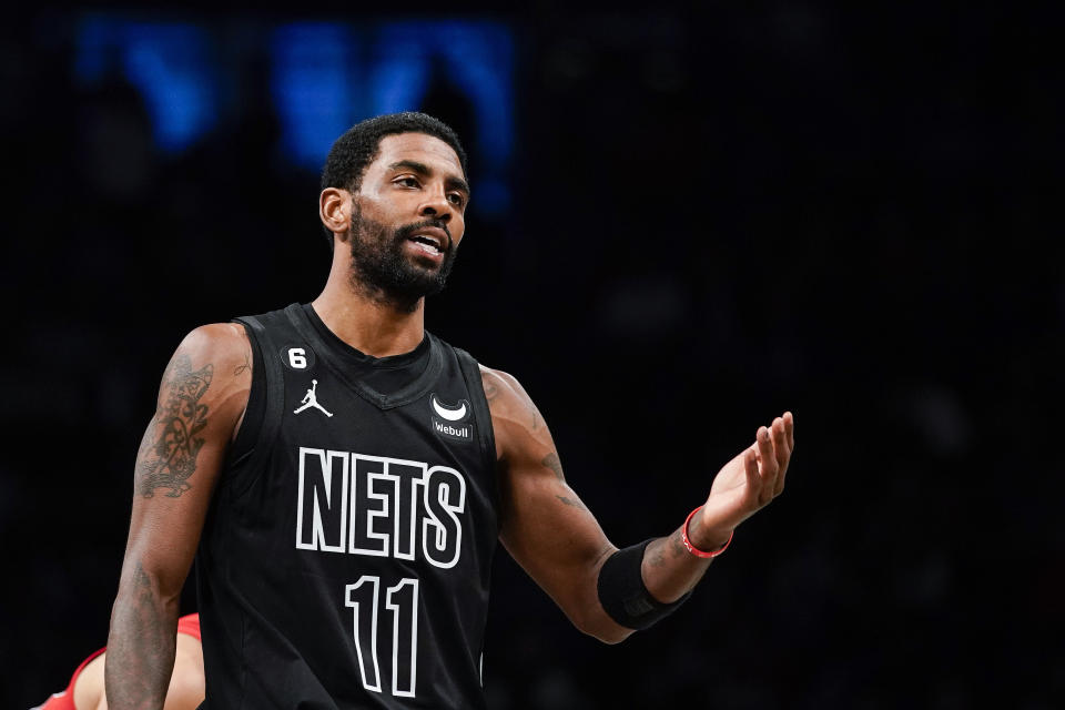 Brooklyn Nets guard Kyrie Irving (11) gestures during the first half of the team's NBA basketball game against the Toronto Raptors on Friday, Dec. 2, 2022, in New York. (AP Photo/Eduardo Munoz Alvarez)