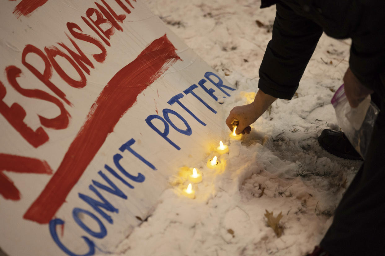 Protesters place electronic candles next to a sign demanding a conviction of former Minneapolis police officer Kim Potter outside of the Hennepin County Government Center on Wednesday, Dec. 22, 2021, in Minneapolis. Potter, who is white, is charged with first- and second-degree manslaughter in the shooting of Daunte Wright, a Black motorist, in the suburb of Brooklyn Center. Potter has said she meant to use her Taser – but grabbed her handgun instead – after Wright tried to drive away as officers were trying to arrest him. (AP Photo/Christian Monterrosa)