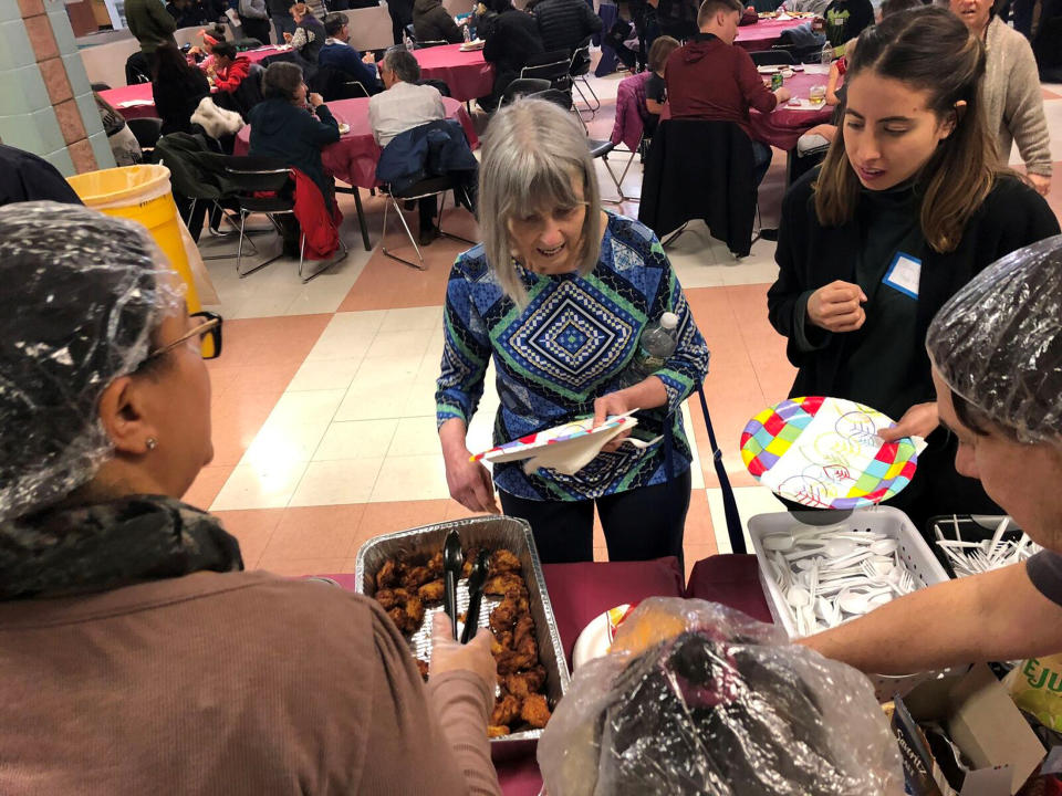 Furloughed government workers, contractors, and their families attended a free community dinner donated from families and community organizations during the partial U.S. government shutdown in Silver Spring, Maryland. (Photo: REUTERS/Arlene Eiras)