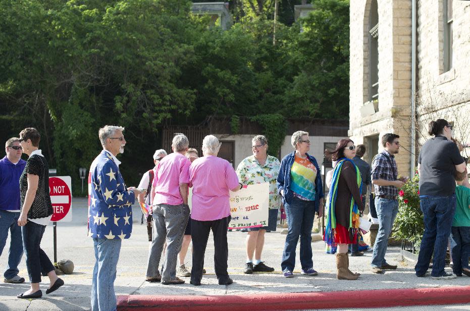 A line forms at the Carroll County Courthouse of same-sex couples waiting to apply for a marriage license Saturday, May 10, 2014, in Eureka Springs, Ark. A judge overturned amendment 83 Friday, which banned same-sex marriage in the state of Arkansas. (AP Photo/Sarah Bentham)