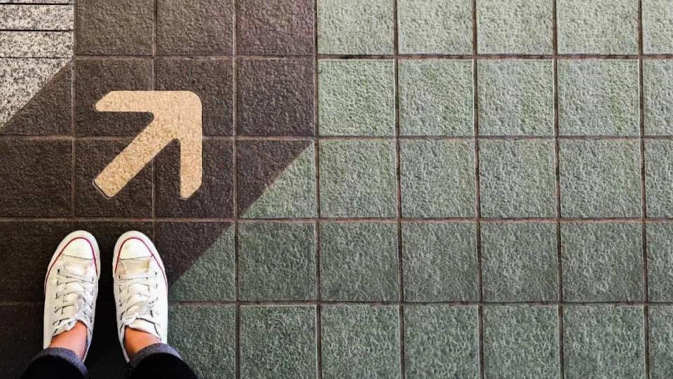 Woman sneaker shoe and Arrow on street with copy space background