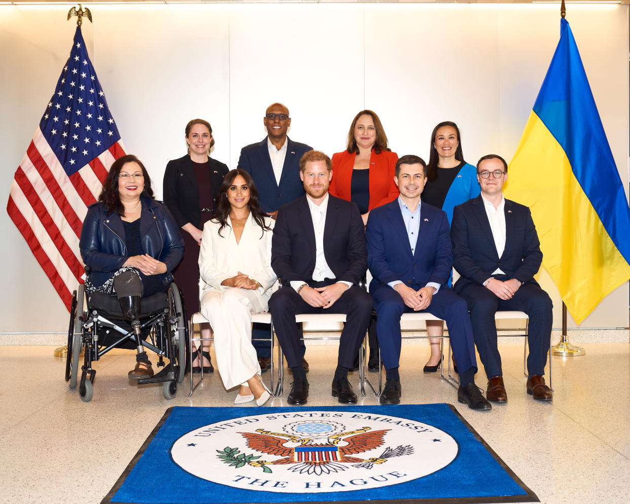 In the back row, from left Rory Brosius, presidential delegate; Donald Remy, U.S. deputy secretary of veterans affairs; Marja Verloop, chargé d'affaires in the U.S. Embassy, and Gina Oritz Jones, under secretary of the Air Force. On the floor is a mat saying United States Embassy, the Hague.