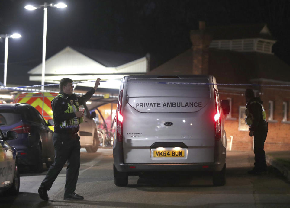A private ambulance arrives at Horsley at the train station, after a murder inquiry was launched following the stabbing of a man on board a train, in Horsley, Surrey, England, Friday, Jan. 4, 2019. British police are searching for a suspect after the fatal stabbing of a man on a suburban London train. British Transport Police said a man was killed Friday on board a train traveling from the town of Guildford to London Waterloo. (Steve Parsons/PA via AP)