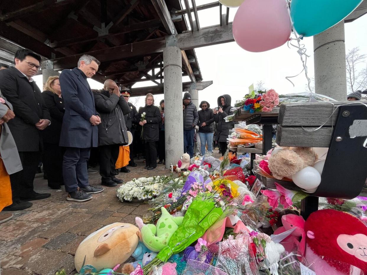 Ottawa Mayor Mark Sutcliffe, second from left, paid respects to the victims of a mass killing in Barrhaven at a vigil March 9, 2024. He called the event 'one of the most shocking incidents of violence in our city's history.' (Camille Kasisi-Monet/Radio-Canada - image credit)