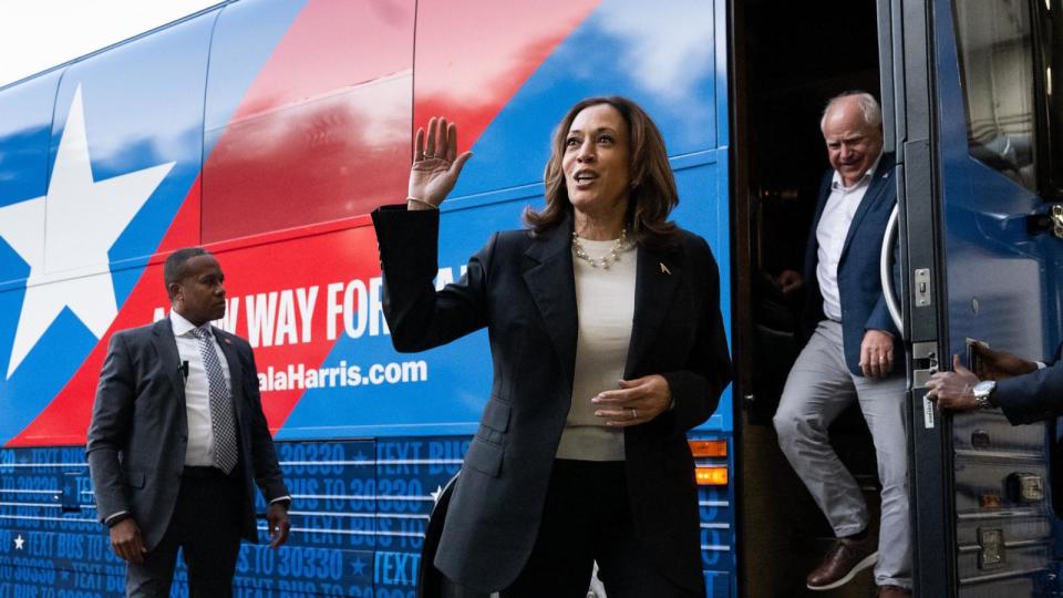 PHOTO: Democratic presidential candidate Vice President Kamala Harris and her running mate, Minnesota Gov. Tim Walz, disembark from their campaign bus in Savannah, Georgia, Aug. 28, 2024, as they travel across Georgia for a 2-day campaign bus tour.  (Saul Loeb/AFP via Getty Images)