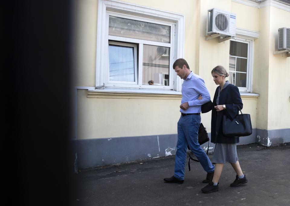 FILE - In this file photo taken on July 26, 2019, opposition candidate and lawyer at the Foundation for Fighting Corruption, Lyubov Sobol leaves the Russian Investigative Committee with her lawyer after been summoned for questioning, in Moscow, Russia. Sobol, who was on a hunger strike for a month protesting an official refusal to register her to run for the Moscow city legislature, argues that the Kremlin won't be able to stop the rising wave of public discontent as more and more Russians are losing trust in authorities. (AP Photo/Pavel Golovkin, File)