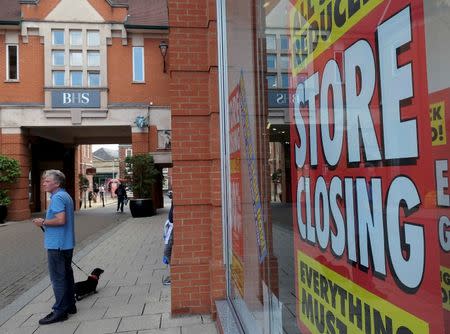 A pedestrian stands in front of a British Home Stores (BHS) branch in Chesterfield, Britain June 26, 2016. Photograph taken June 26, 2016. REUTERS/Andrew Yates