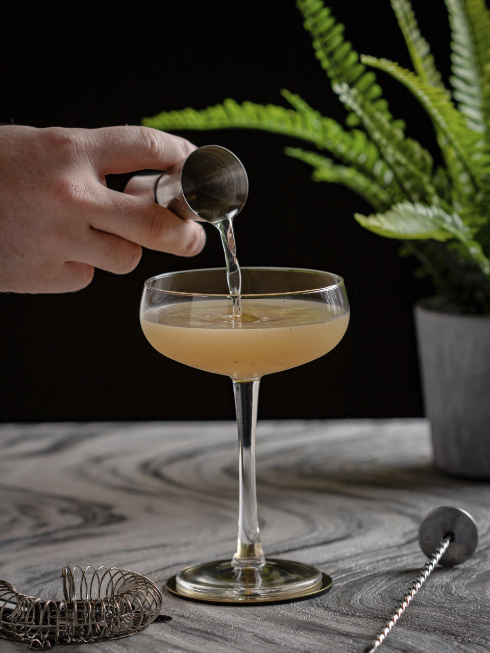 This image shows a buttered rum cocktail being prepared. (Callum Duffy via AP)