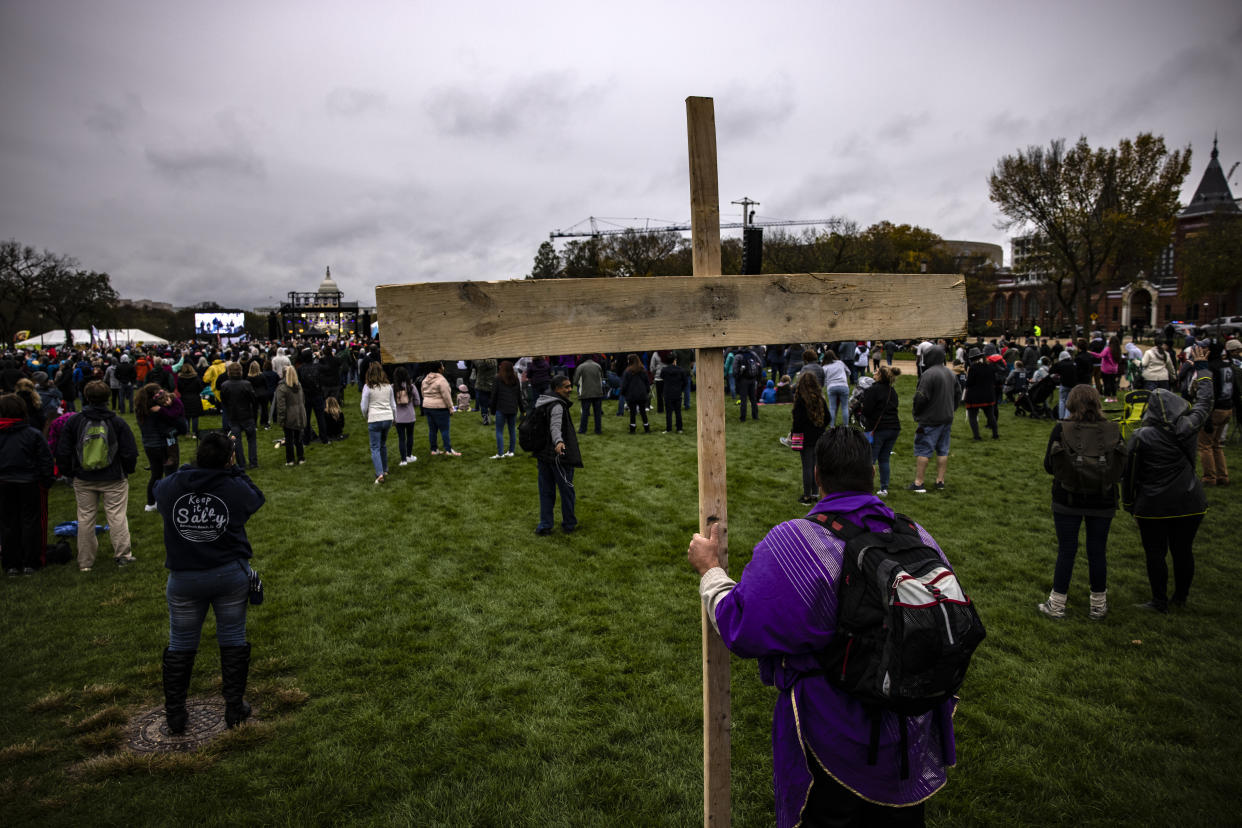 A man carries a large wooden cross during an event and concert put on by evangelical musician Sean Feucht on the National Mall on October 25, 2020 in Washington, DC. (Samuel Corum/Getty Images)