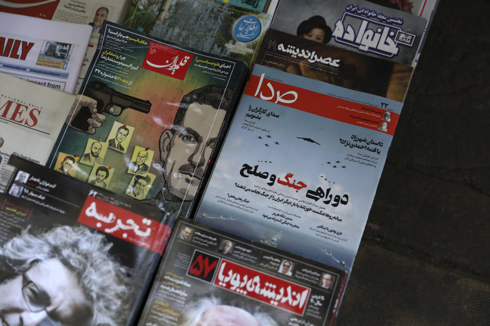 The front cover of the May 11, 2019 edition of the weekly reformist magazine, Seda, center right, is on display at a news stand in downtown Tehran, Iran, May 12, 2019. Iranian authorities shut down the magazine that had urged negotiations with the United States, local media reported Sunday. (AP Photo/Vahid Salemi)