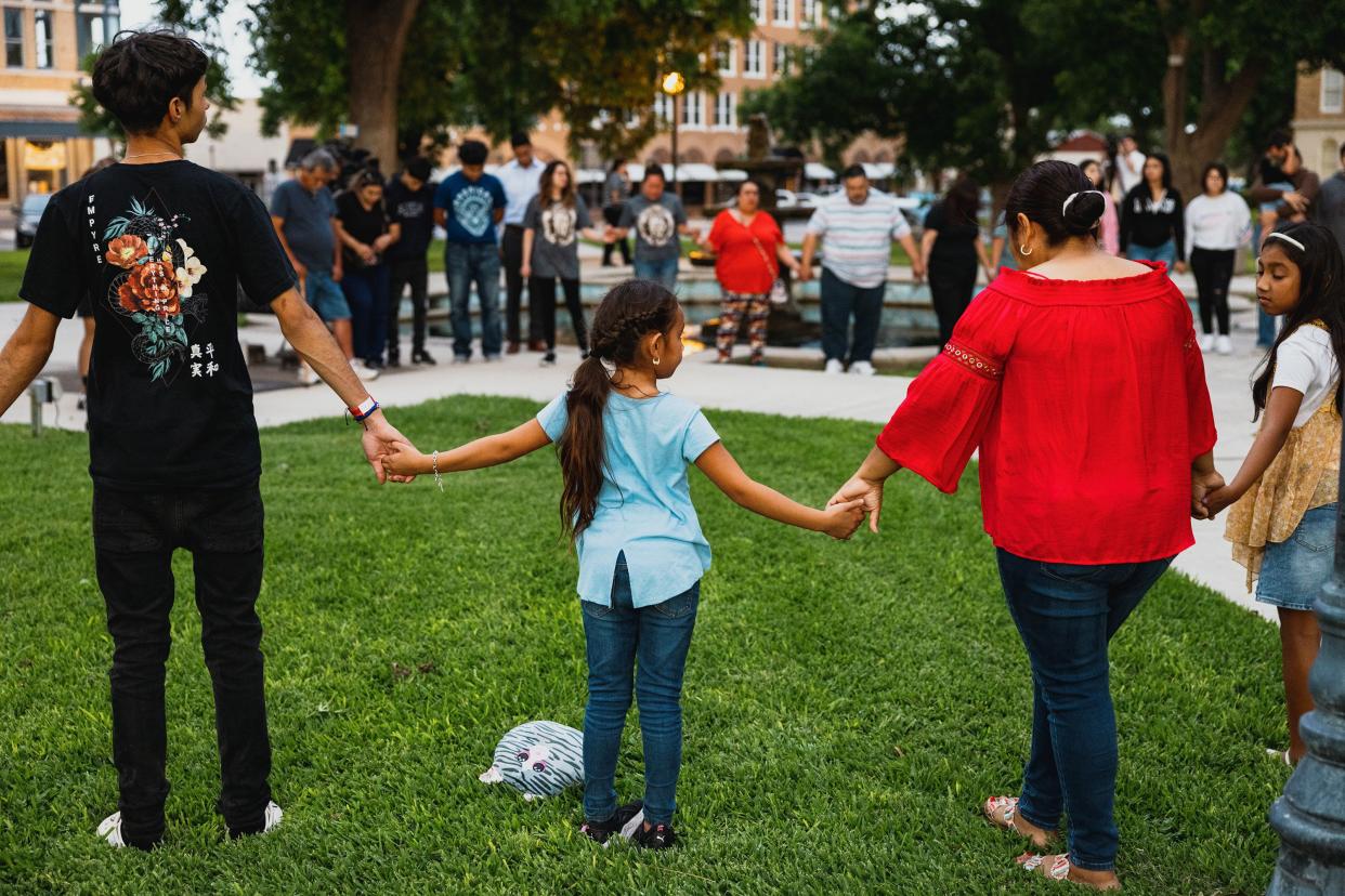 Members of the community gather at the City of Uvalde Town Square for a prayer vigil in the wake of a mass shooting at Robb Elementary School on May 24, 2022, in Uvalde, Texas. According to reports, 19 students and 2 adults were killed before the gunman was fatally shot by law enforcement.