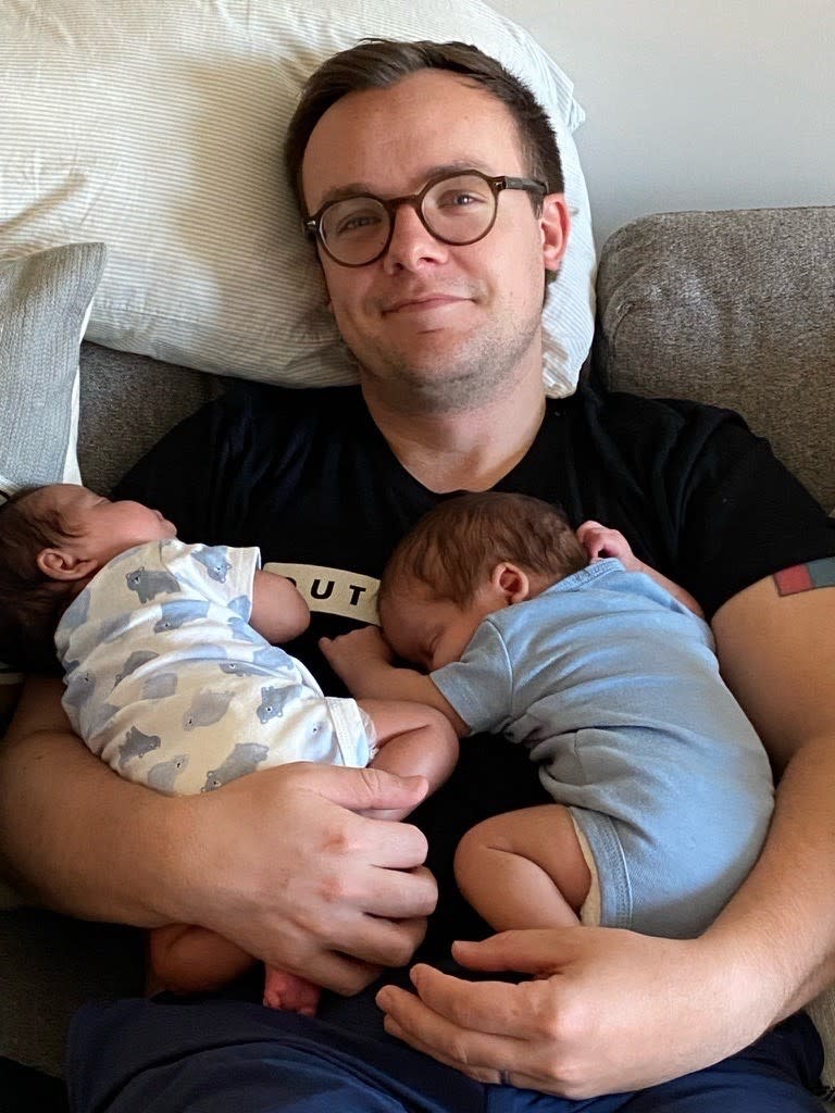 Chasten Buttigieg embraces his newborns, soon after he and his husband brought them home from the hospital. (Courtesy Pete Buttigeg/Medium) 